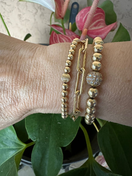 The Mini Gampanion is the bracelet on the left.  To get this look, add the Paperclip chain bracelet (middle) and the Gampanion (on the right)
